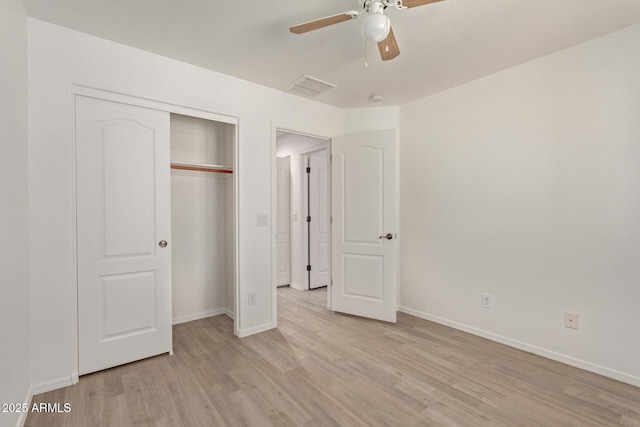 unfurnished bedroom featuring light hardwood / wood-style flooring, a closet, and ceiling fan