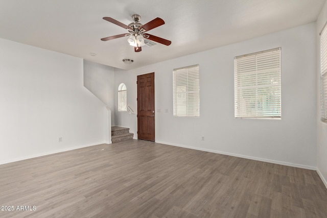 empty room featuring ceiling fan and light hardwood / wood-style floors