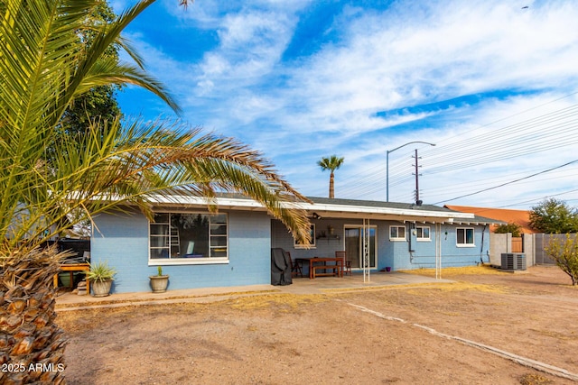 single story home with central AC unit and a patio area