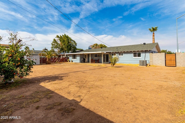 rear view of property with central AC unit