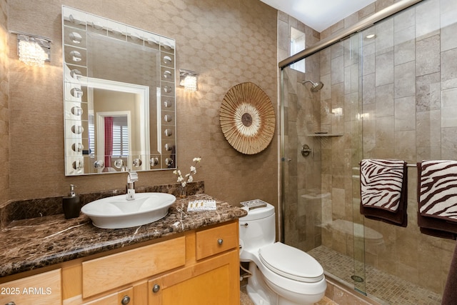 full bathroom with a stall shower, vanity, and toilet