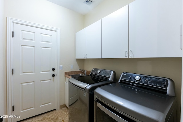 laundry area with cabinet space, independent washer and dryer, visible vents, and a sink