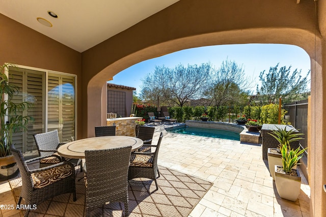 view of patio with a fenced in pool, outdoor dining space, and a fenced backyard