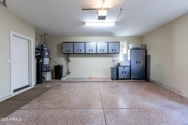 garage with water heater and a garage door opener