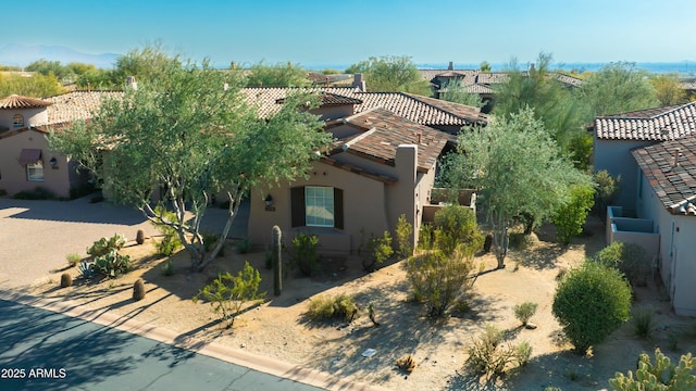 view of front of house with a tiled roof and stucco siding