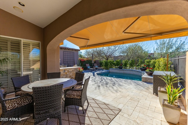 view of patio / terrace with a fenced backyard, a fenced in pool, and outdoor dining space