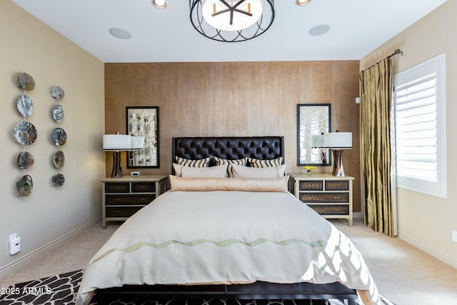 bedroom featuring light carpet and baseboards