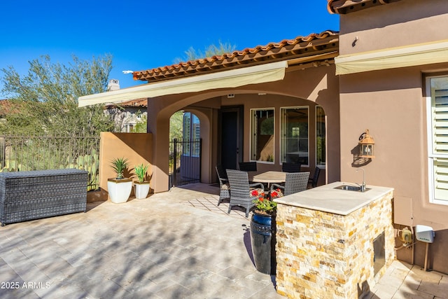 view of patio with a bar and fence