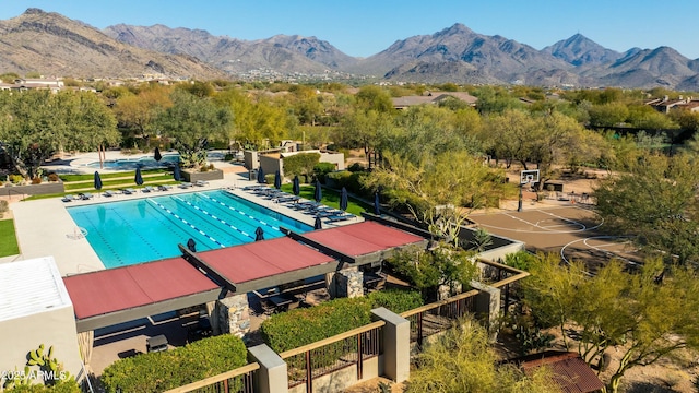 pool featuring fence and a mountain view