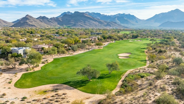 birds eye view of property with view of golf course and a mountain view