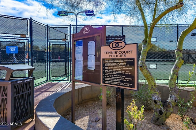 view of property's community featuring fence and a gate