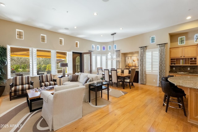 living room with recessed lighting, visible vents, and light wood-style floors