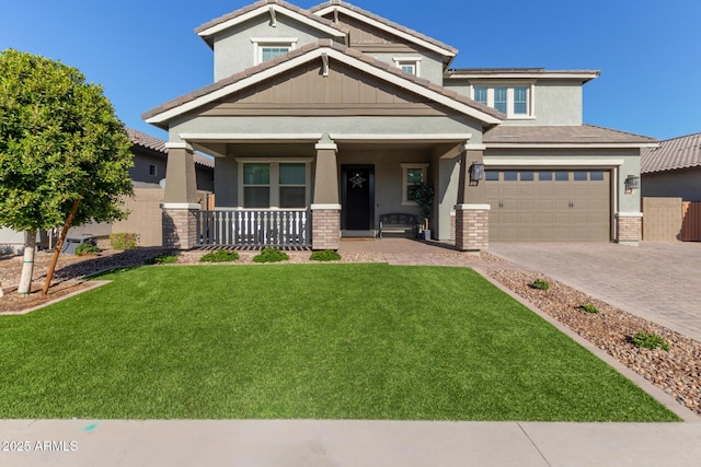 craftsman house featuring a porch, a front yard, and a garage