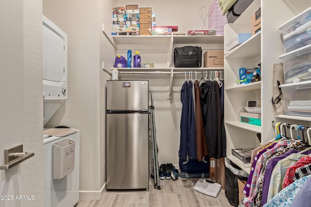 spacious closet featuring stacked washer and clothes dryer