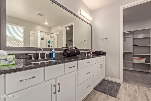 bathroom with an enclosed shower and vanity