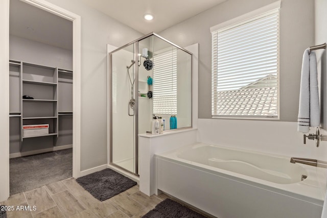 bathroom featuring separate shower and tub