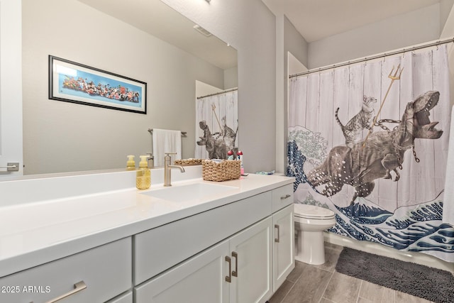 bathroom featuring toilet and vanity