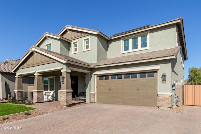 craftsman inspired home featuring covered porch and a garage