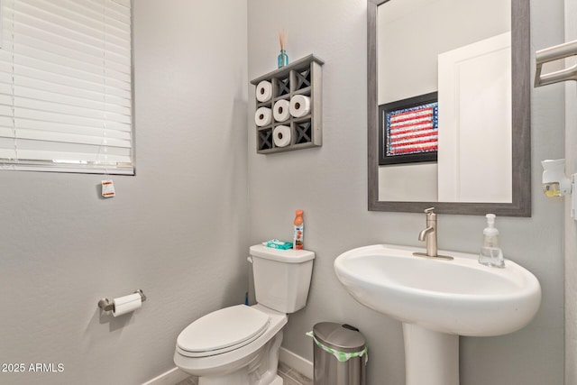 bathroom featuring toilet and sink