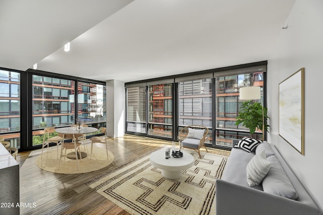 sitting room featuring hardwood / wood-style flooring and a wall of windows