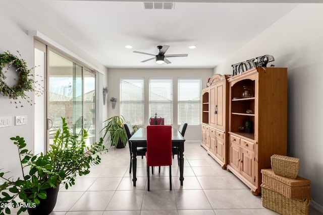 dining space with a ceiling fan, visible vents, plenty of natural light, and light tile patterned floors