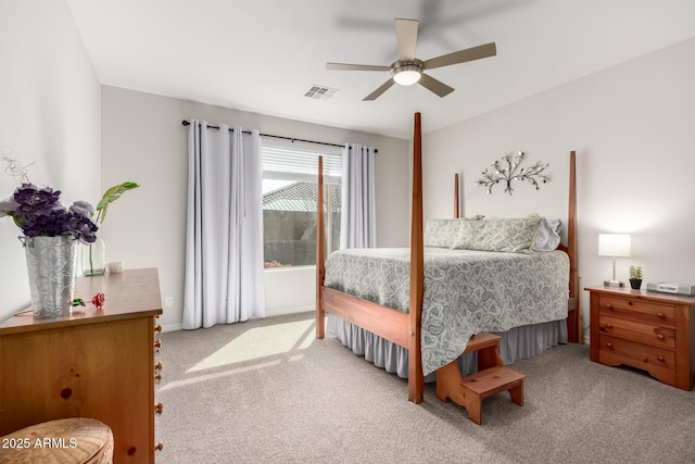 carpeted bedroom featuring ceiling fan and visible vents