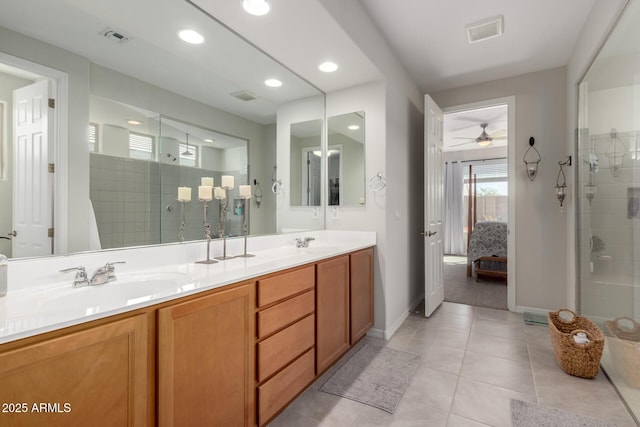 full bath with ensuite bath, a shower stall, visible vents, and a sink