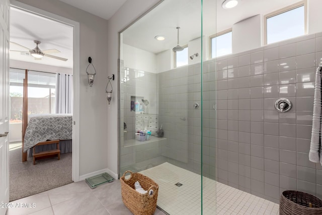 ensuite bathroom featuring a ceiling fan, connected bathroom, a tile shower, tile patterned flooring, and baseboards