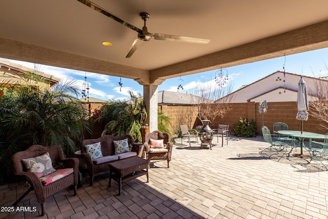 view of patio with a ceiling fan, outdoor dining space, a fenced backyard, and an outdoor living space