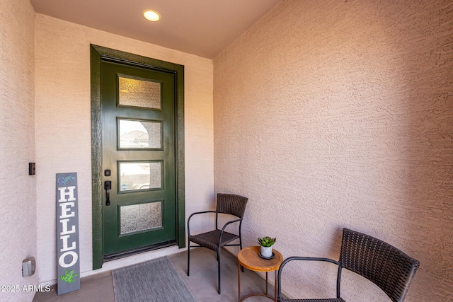 property entrance with stucco siding