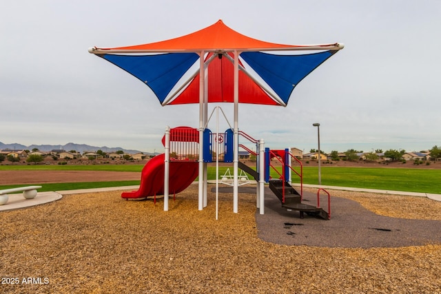 community play area with a yard and a mountain view