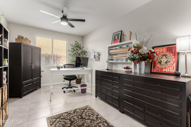 office space with light tile patterned floors, baseboards, and a ceiling fan