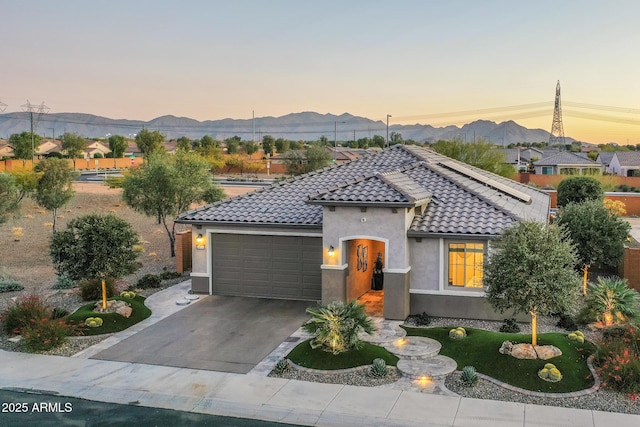 view of front of property with a mountain view and a garage