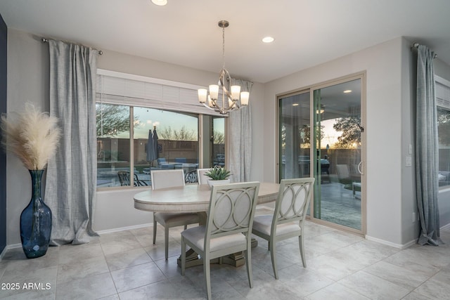 dining room with light tile patterned flooring and a notable chandelier