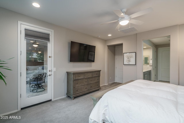 bedroom featuring connected bathroom, light colored carpet, and ceiling fan