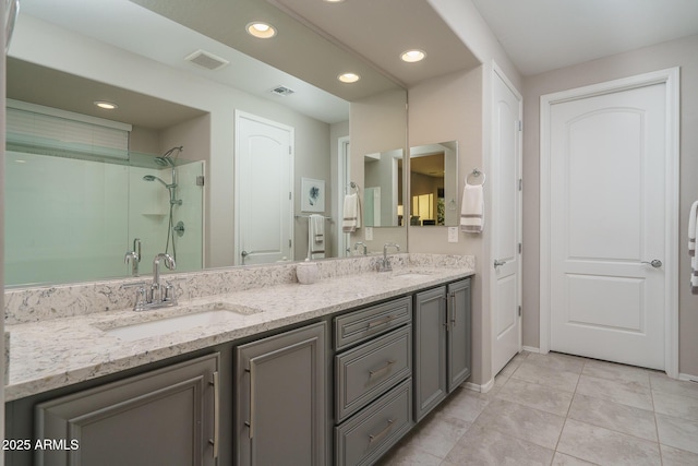 bathroom featuring vanity, tile patterned flooring, and walk in shower