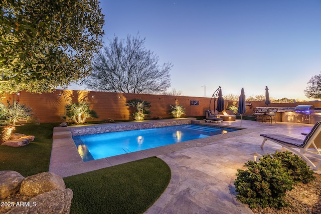 pool at dusk featuring a patio area