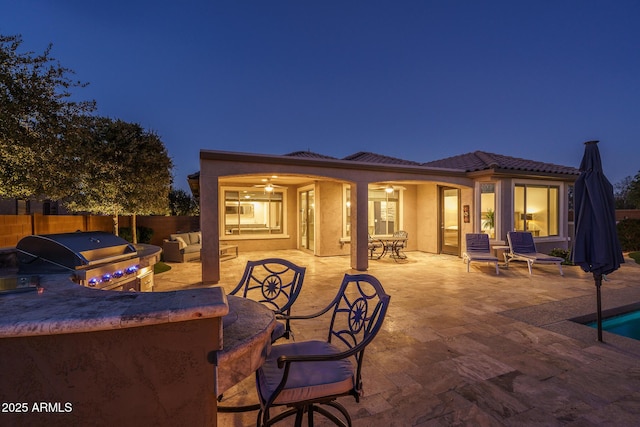 rear view of property with area for grilling and a patio