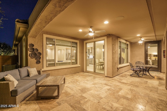 patio at twilight with an outdoor hangout area and ceiling fan