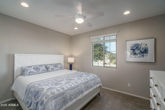 bedroom featuring ceiling fan and dark carpet