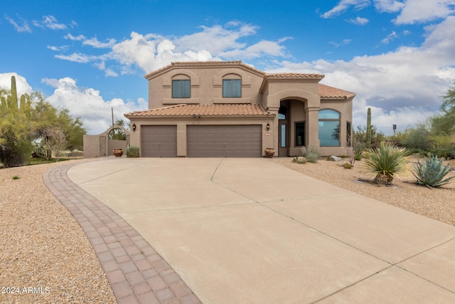 mediterranean / spanish-style home featuring a garage