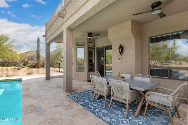 view of patio featuring a fenced in pool and ceiling fan