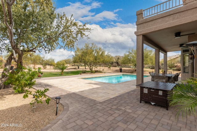 view of pool with ceiling fan and a patio area