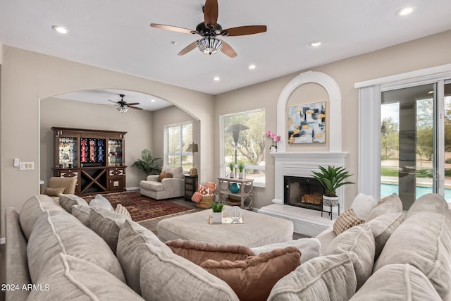 living room featuring ceiling fan and dark wood-type flooring