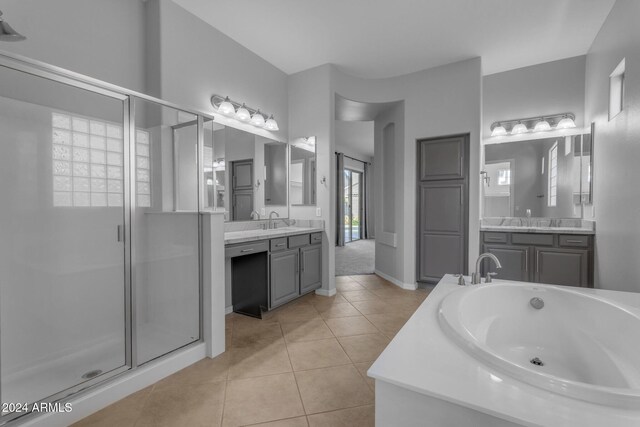 bathroom with tile patterned floors, separate shower and tub, and vanity