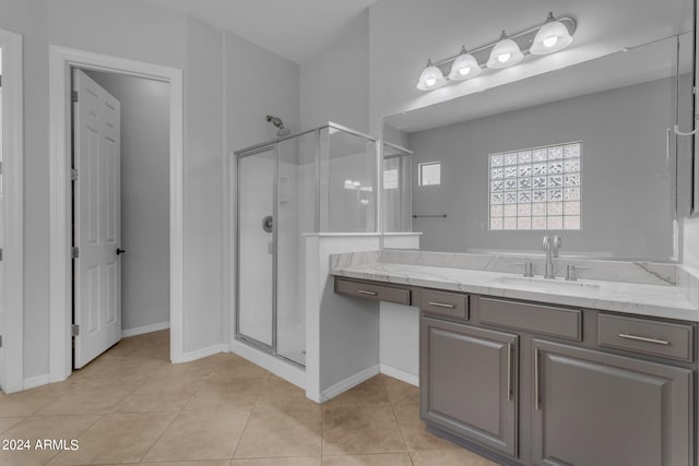 bathroom featuring vanity, tile patterned flooring, and a shower with door