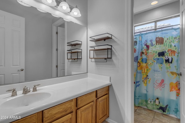 bathroom with a shower with curtain, vanity, and tile patterned flooring