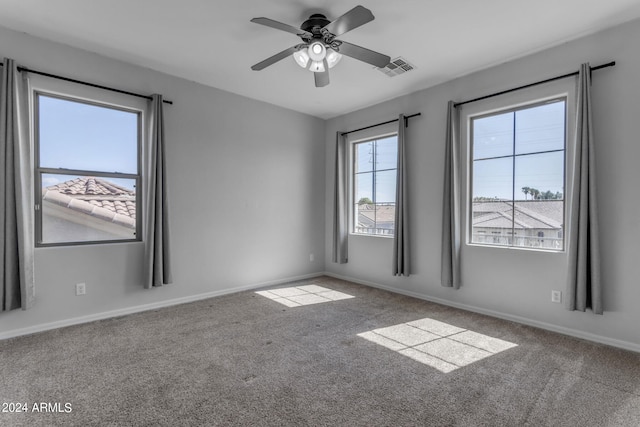 empty room with ceiling fan and carpet