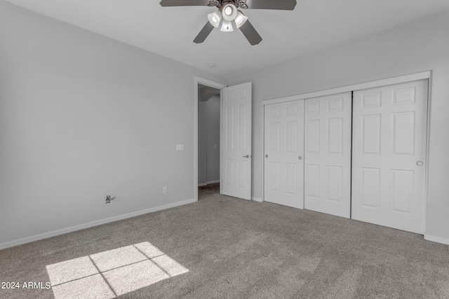 unfurnished bedroom with ceiling fan, carpet floors, and a closet