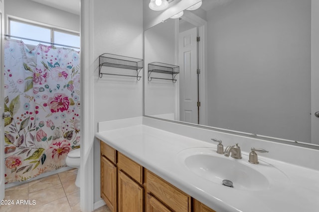 bathroom with vanity, tile patterned flooring, toilet, and walk in shower